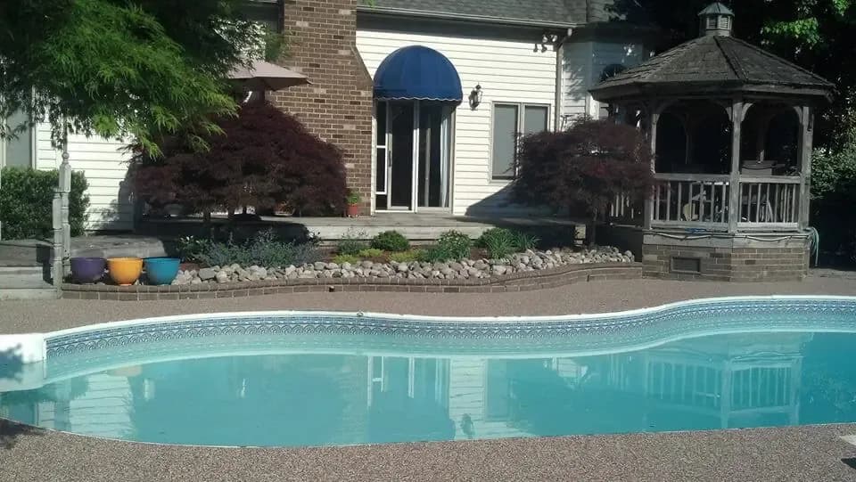 Pool corner at sunset with a brown Rubber Stone deck